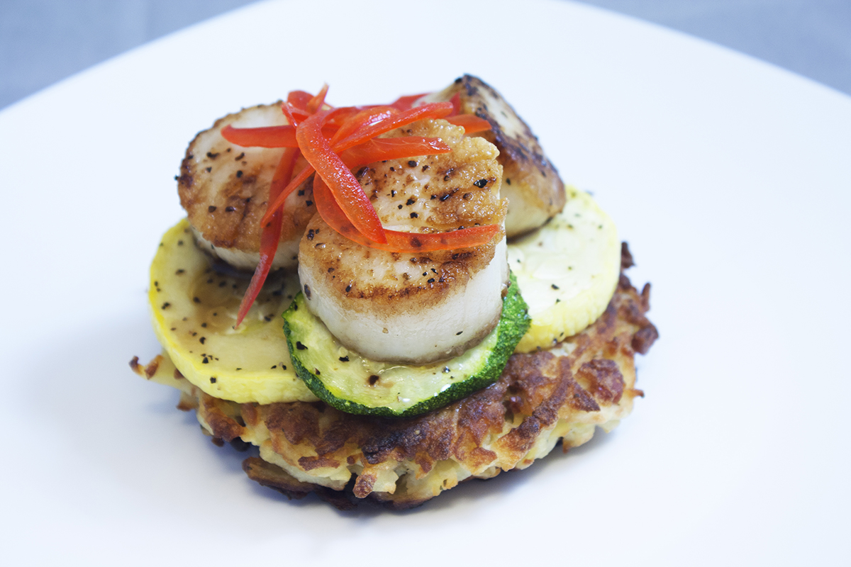Scallops on vegetables and potato latke